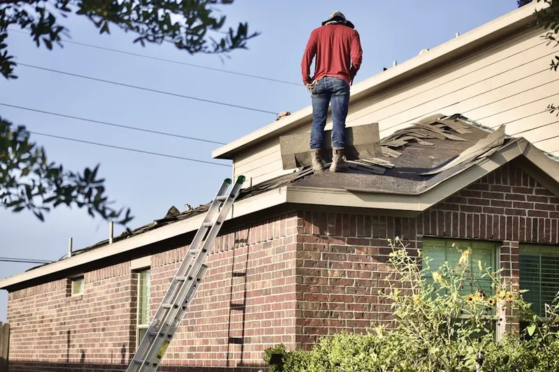 Professional roofer working on a residential roof in Downtown Grand Prairie